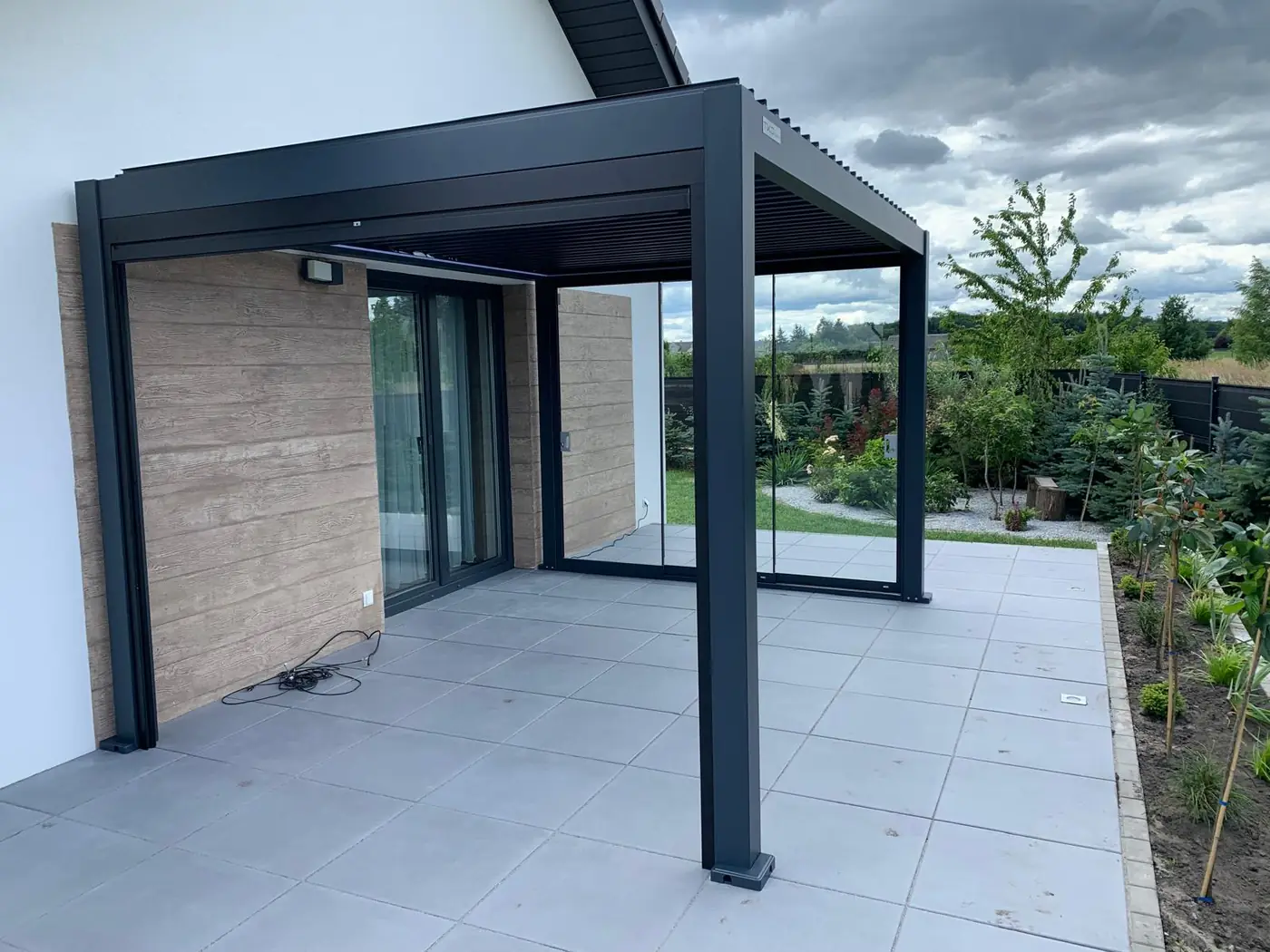 Wnętrze pergoli aluminiowej 3×4 w Tryszczynie - szklane drzwi przesuwne i dach lamelowy
