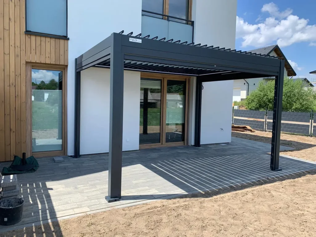 Pergola ogrodowa BASE 4×3 w Świeciu - konstrukcja przyścienna przy elewacji z drewnianym oblicowaniem